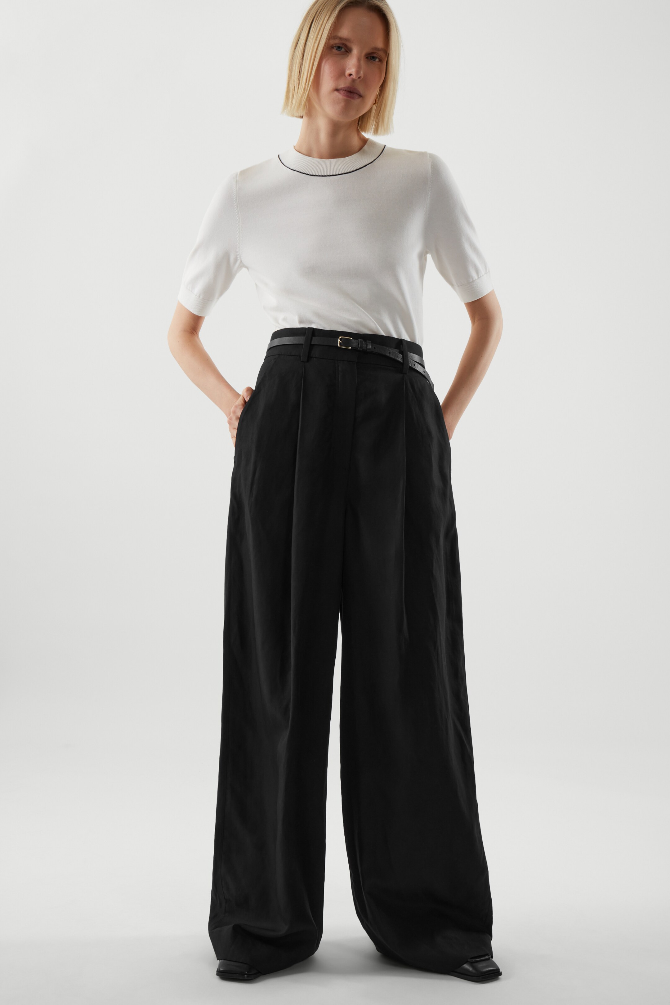 Front image of cos HIGH-WAISTED WIDE-LEG TROUSERS in BLACK