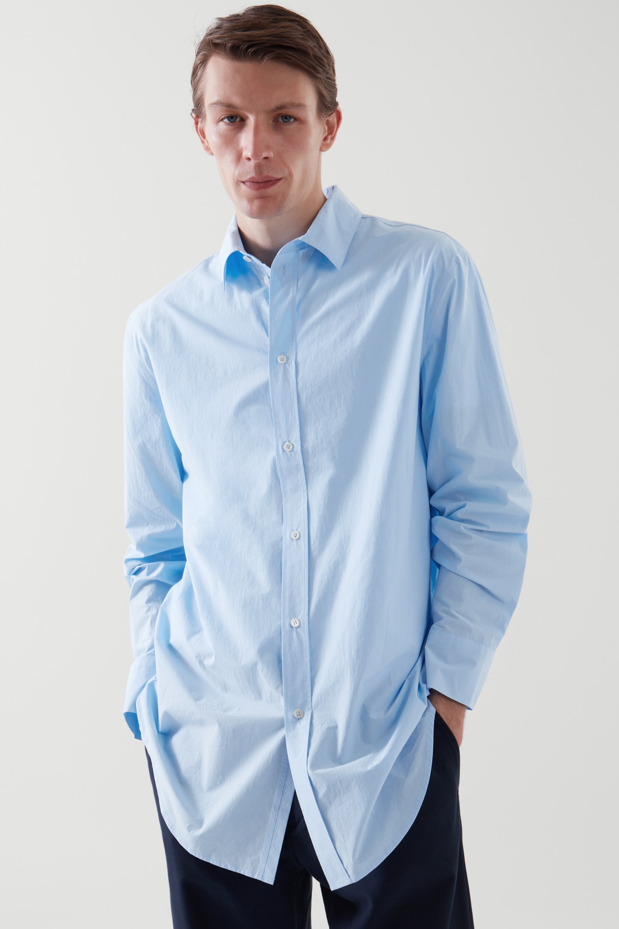 Front image of cos RELAXED-FIT LONGLINE POPLIN SHIRT in LIGHT BLUE