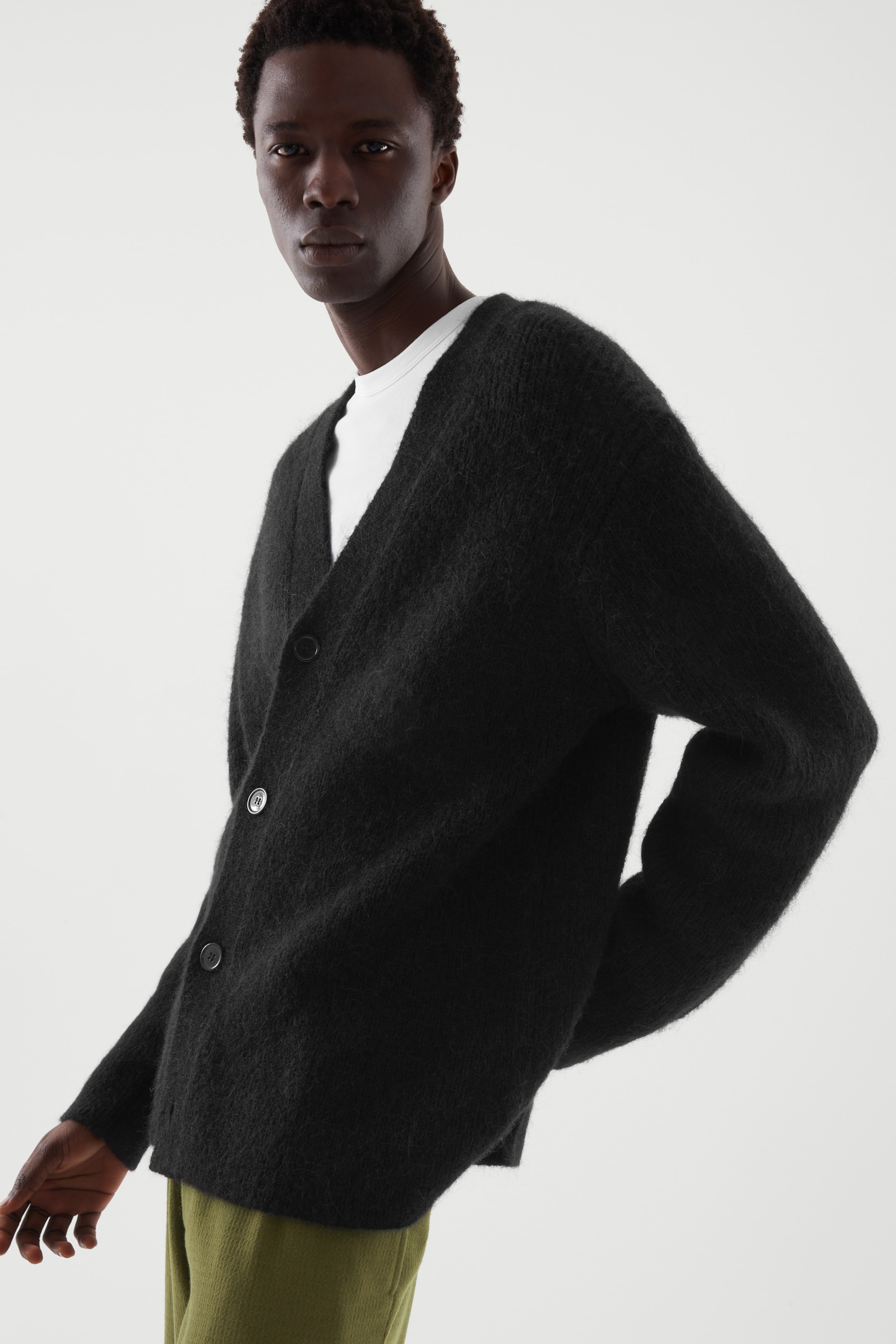 Front image of cos RELAXED-FIT MERINO WOOL CARDIGAN in black